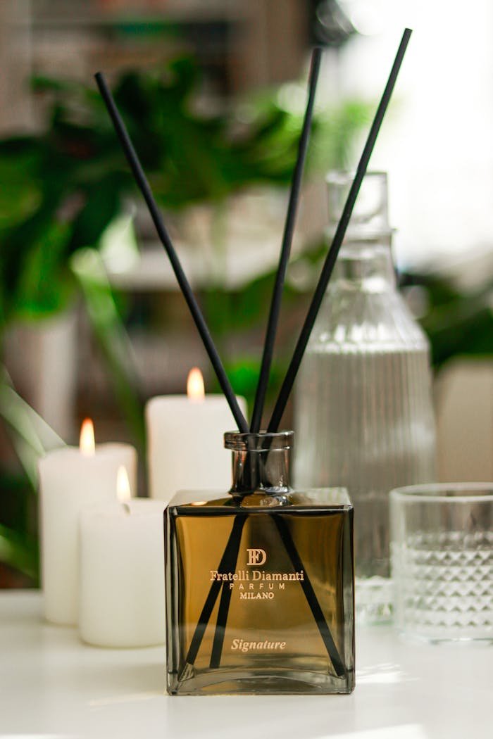 about-01 Fratelli Diamanti signature fragrance diffuser surrounded by candles, ideal for relaxation.
